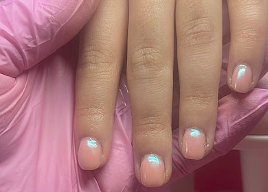 Glistening pink nails finished at Built By Mikaela in Skewen, Wales, GB, showcasing expert nail styling.