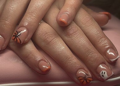 Halloween-themed nails at Built By Mikaela in Skewen, Wales, GB with pumpkin and ghost designs.