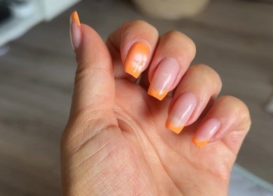 Vibrant orange manicured nails by Beauty by Mel in Glenfield, England, GB.