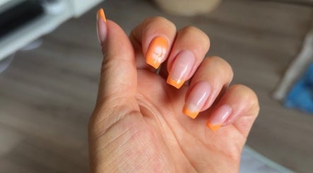 Vibrant orange manicured nails by Beauty by Mel in Glenfield, England, GB.