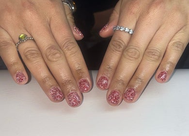 Sparkling pink manicure at Beauty by Mel in Glenfield, England, GB showcasing elegant nail art.
