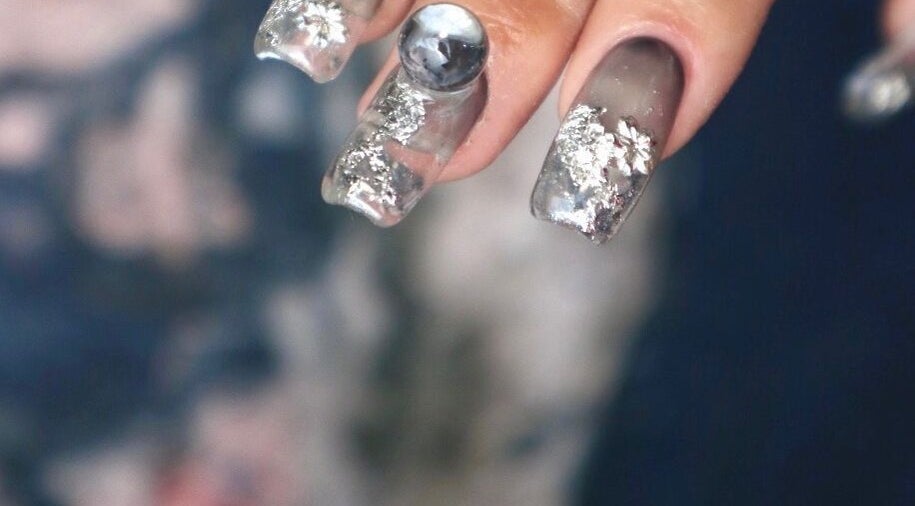 Elegant silver nail art at Nail Salon MEIKA, Meguro-ku, Tokyo. Exquisite designs enhance style and beauty.