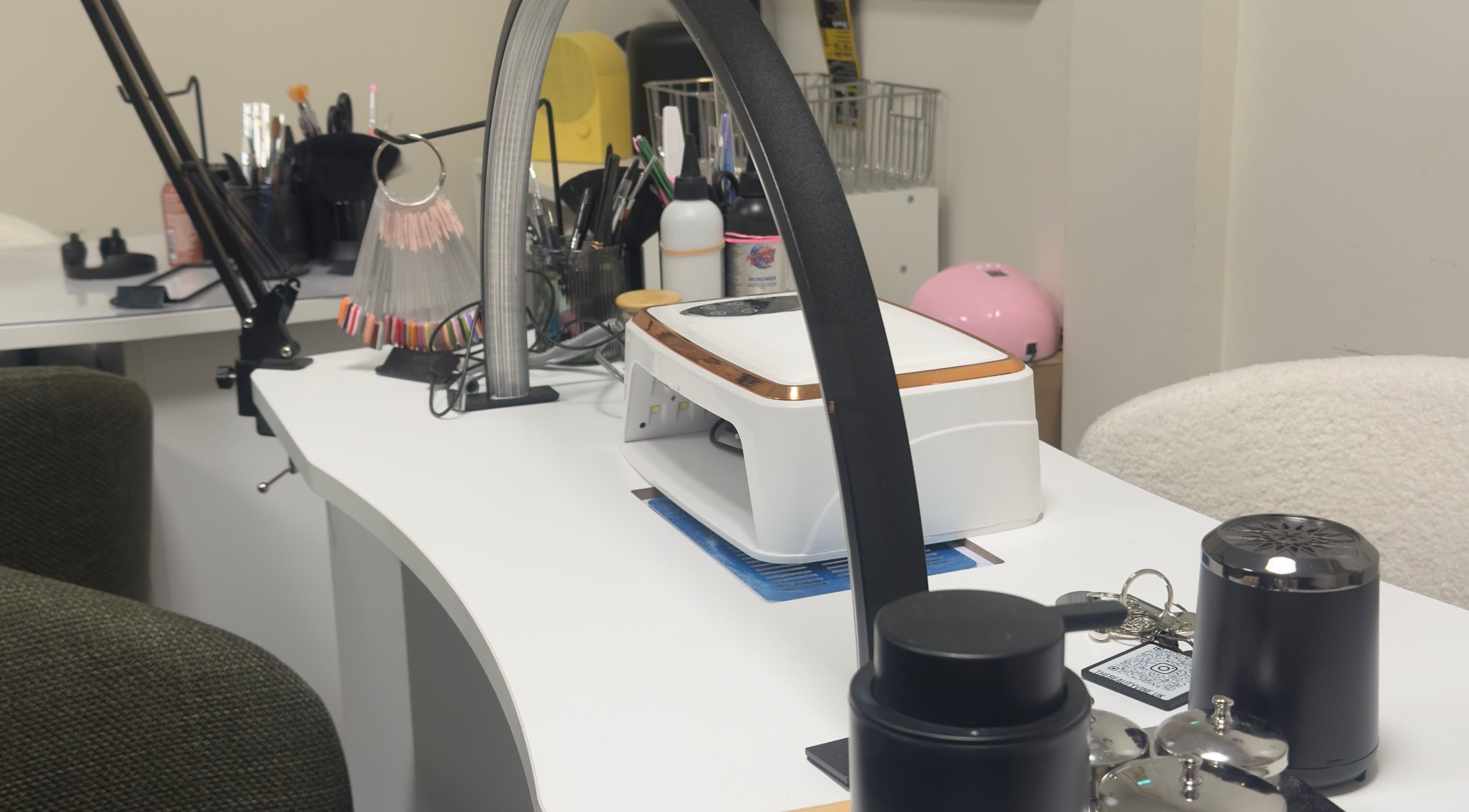 Modern nail station at TheBeautyVine, Birmingham, England, GB. Equipped with tools for manicure services.