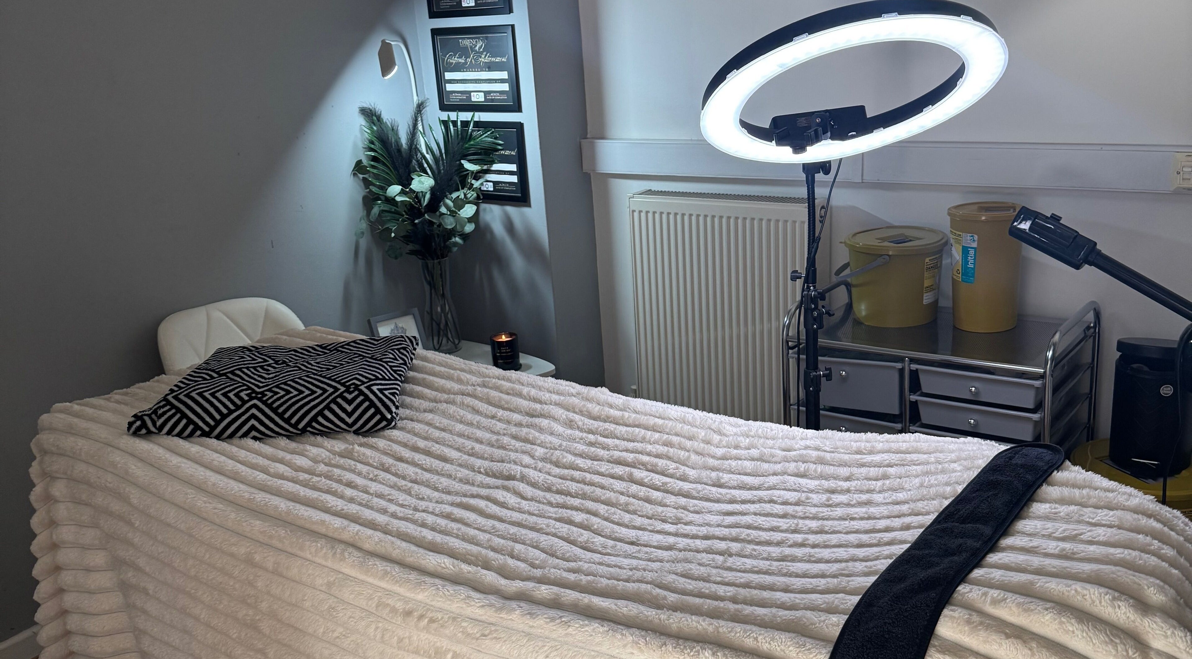 Cozy treatment room at La Bella Beauty in Golborne, England, GB with plush bedding and soft lighting.