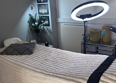 La Bella Beauty treatment room in Golborne, England, GB, featuring a cozy bed and soft ambient lighting.