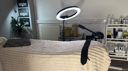 Cozy treatment room at La Bella Beauty in Golborne, England, GB with soft lighting and comfortable bed.
