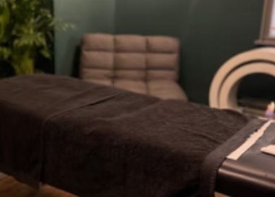 Cozy therapy room at LS Sport Therapy, Leeds, England, GB with massage table and soft lighting.