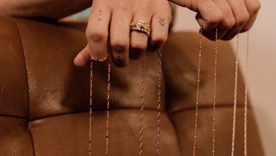 Hand displaying delicate chains at Wild Rose in Lincoln, Nebraska, US.