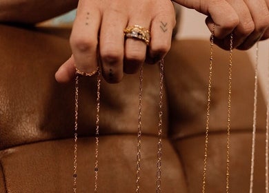 Hand displaying delicate chains at Wild Rose in Lincoln, Nebraska, US.