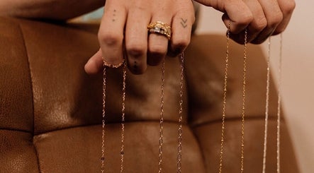 Hand displaying delicate chains at Wild Rose in Lincoln, Nebraska, US.
