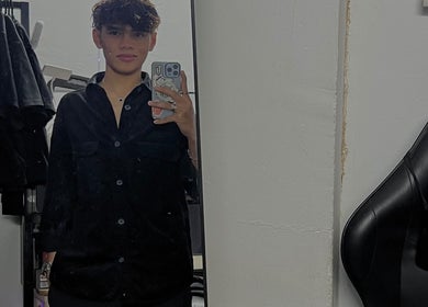 A stylish person taking a mirror selfie at zack.haircuts in Klang, Selangor, MY, with modern salon background.