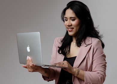 Professional at Karine Chimenes Aesthetics, Falmouth, Massachusetts, US working on a laptop.