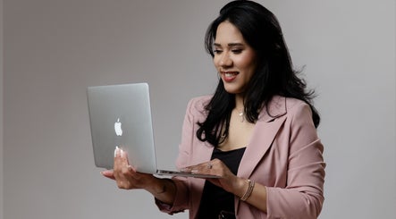 Professional at Karine Chimenes Aesthetics, Falmouth, Massachusetts, US working on a laptop.