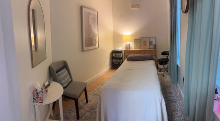 Tranquil massage room in Balance Bodywork by Lynsey, Claremont, North Carolina, US, with cozy lighting.