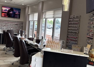 Stylish interior of La vogue nail & lash, Lone Tree, Colorado, US with comfortable seating and nail polish display.