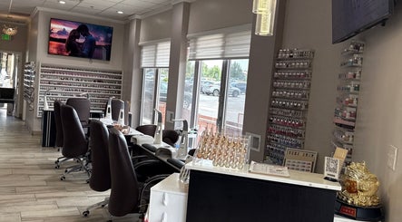 Stylish interior of La vogue nail & lash, Lone Tree, Colorado, US with comfortable seating and nail polish display.