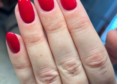 Vibrant red manicure at Femme Lounge, Rutherglen, Scotland, GB capturing elegant nail art.