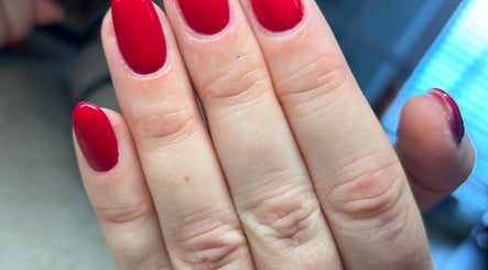 Vibrant red manicure at Femme Lounge, Rutherglen, Scotland, GB capturing elegant nail art.