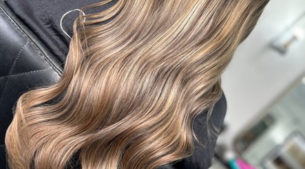 Long, wavy blonde hair styled at Emilia Grace Hair in Birmingham, England, GB, showcasing vibrant highlights.