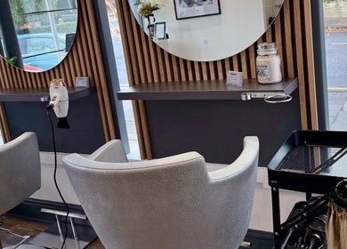 Modern styling station at Emilia Grace Hair, Birmingham, England, GB with chic chairs and hair tools.