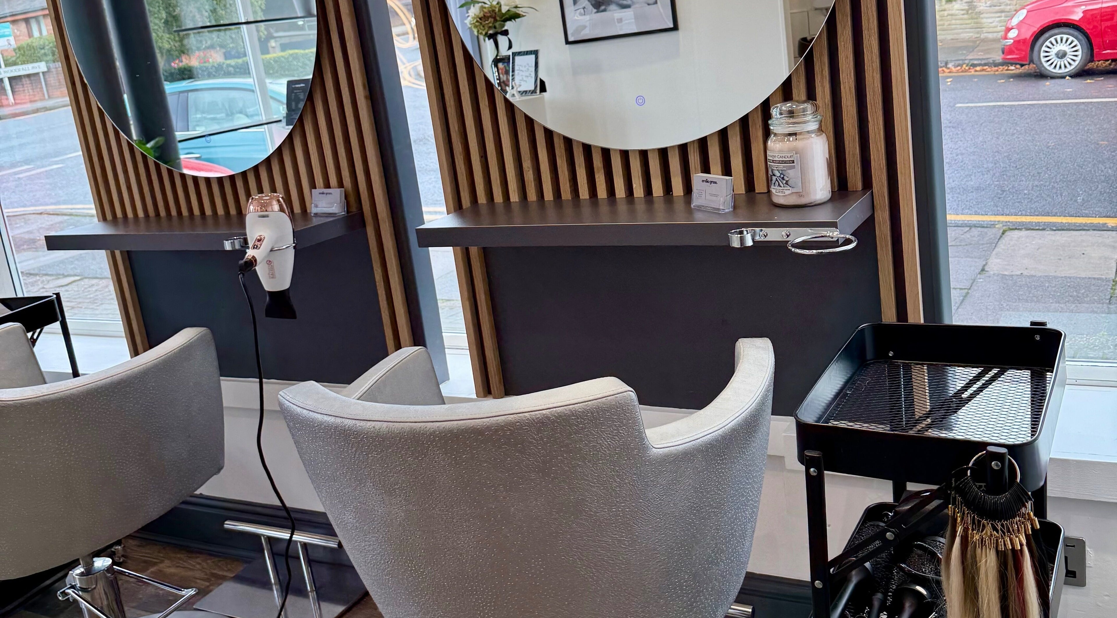 Modern styling station at Emilia Grace Hair, Birmingham, England, GB with chic chairs and hair tools.