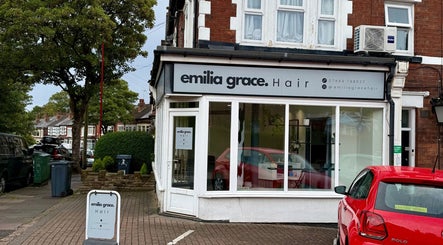 Exterior of Emilia Grace Hair salon in Birmingham, England, GB, featuring signage and a street view.