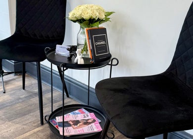 Chic waiting area with black chairs and decor at Emilia Grace Hair, Birmingham, England, GB.