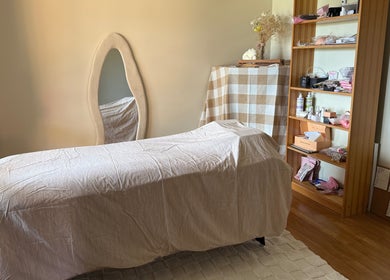 Serene treatment room at Refined Beauty by Kate, Worrigee, New South Wales, AU with a cozy massage table.