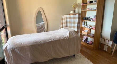 Serene treatment room at Refined Beauty by Kate, Worrigee, New South Wales, AU with a cozy massage table.