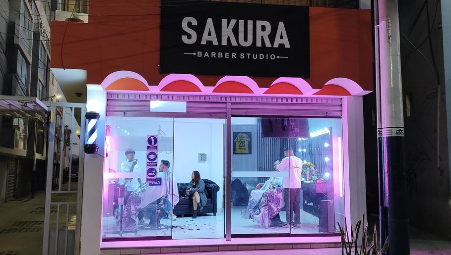 Vista nocturna de SAKURA BARBER STUDIO en Arequipa, Arequipa, PE con clientes recibiendo servicios de belleza.
