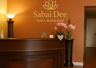 Reception area at Sabai Dee Thai Massage, Newport Beach, US, with flowers and elegant decor.