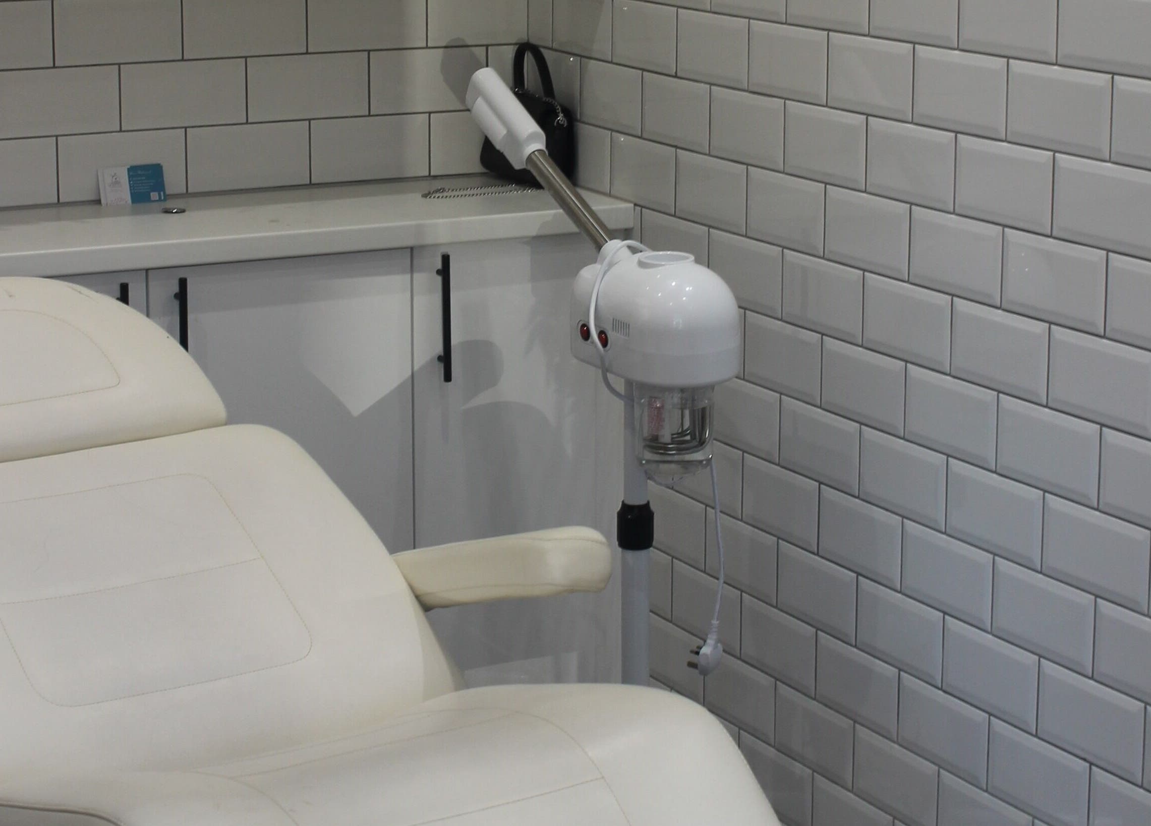 Stylish spa room at Ultimate Beauty in Edinburgh, Scotland, GB, featuring a plush treatment chair and modern decor.