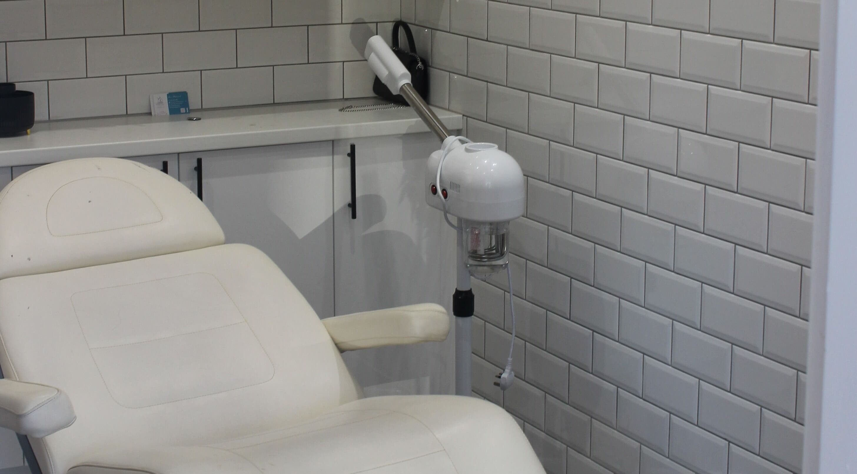 Stylish spa room at Ultimate Beauty in Edinburgh, Scotland, GB, featuring a plush treatment chair and modern decor.
