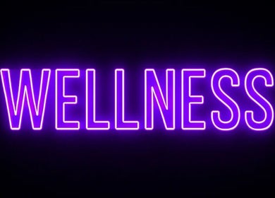 Bright neon sign reading 'Wellness' at TT Wellness, Melbourne, Victoria, AU.
