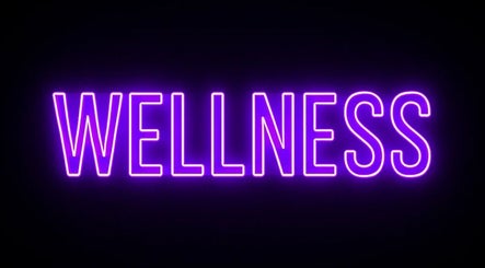 Bright neon sign reading 'Wellness' at TT Wellness, Melbourne, Victoria, AU.