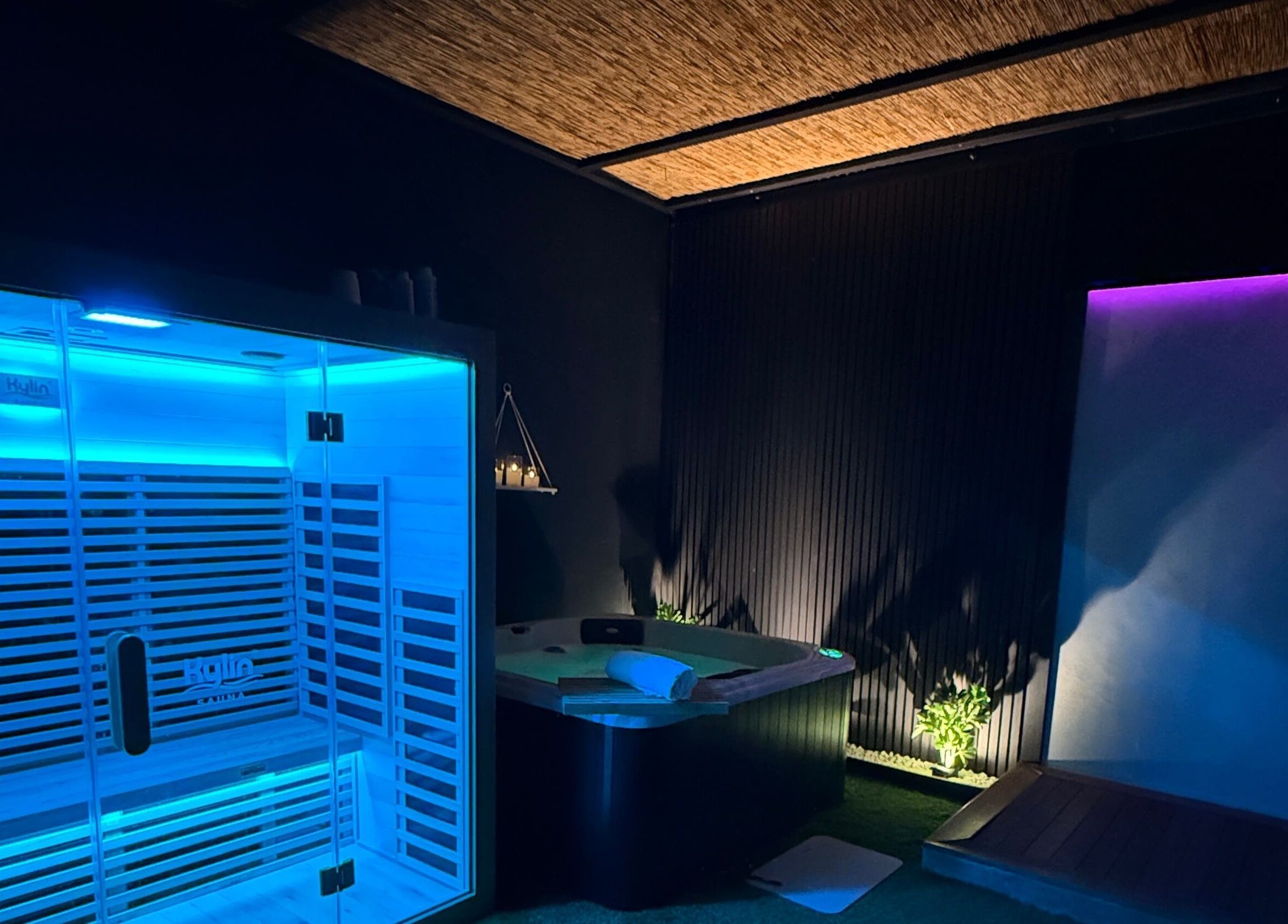 Relaxing spa room at TT Wellness, Melbourne, Victoria, AU with illuminated sauna and candles.