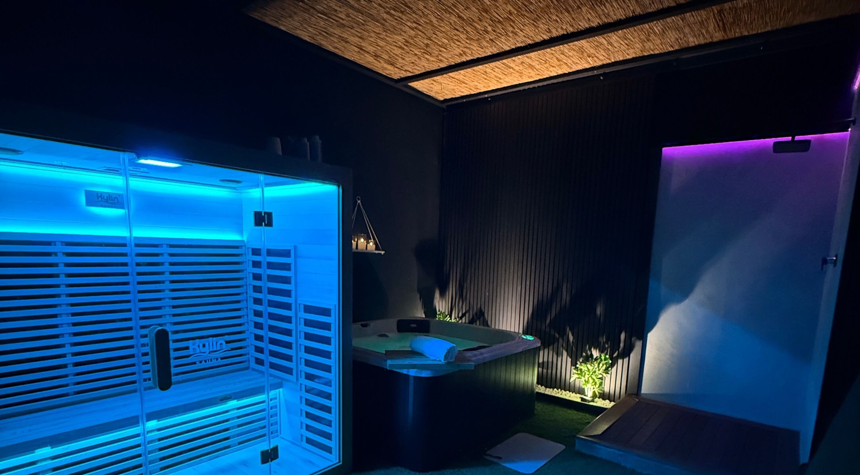 Relaxing spa room at TT Wellness, Melbourne, Victoria, AU with illuminated sauna and candles.