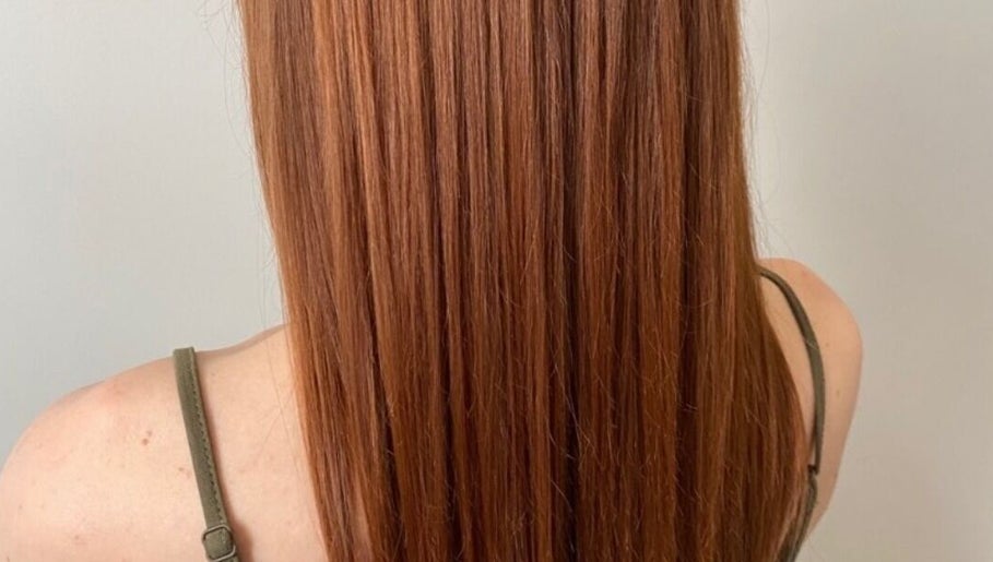 Auburn hair styled flawlessly at LAYER SALON in Longueuil, Québec, CA, showcasing healthy, glossy strands.