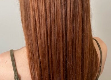 Auburn hair styled flawlessly at LAYER SALON in Longueuil, Québec, CA, showcasing healthy, glossy strands.