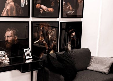 Gallery walls at VEAN Tattoo, Wolverhampton, England, GB, showcasing artistic decor and comfortable seating.