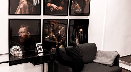 Gallery walls at VEAN Tattoo, Wolverhampton, England, GB, showcasing artistic decor and comfortable seating.