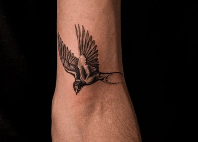 Detailed bird tattoo on wrist at VEAN Tattoo, Wolverhampton, England, GB, showcasing precision and artistry.