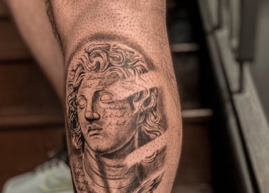 Classical statue tattoo on leg at VEAN Tattoo in Wolverhampton, England, GB, showcasing fine artistry and detail.