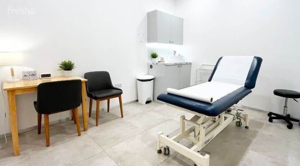 Cozy therapy room at Gosia Massage Therapy in London, England, GB with a massage table and chairs.