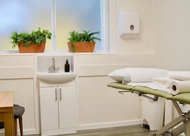 Tranquil massage room at Gosia Massage Therapy Clapham in London, England, GB, with calming decor and greenery.