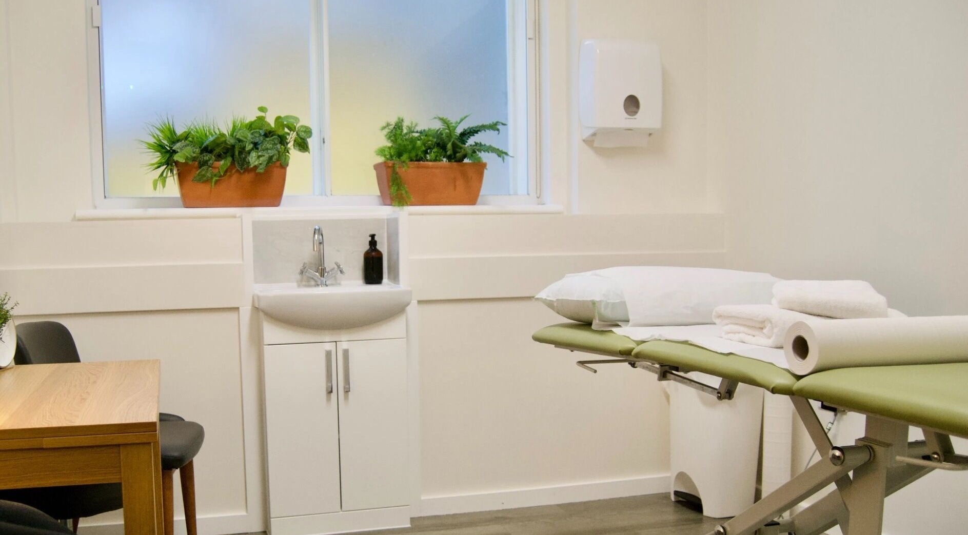 Tranquil massage room at Gosia Massage Therapy Clapham in London, England, GB, with calming decor and greenery.
