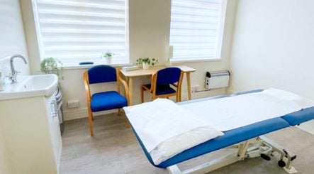 Peaceful therapy room at Gosia Massage Therapy Clapham, London, England, GB. Features massage table and cozy seating.