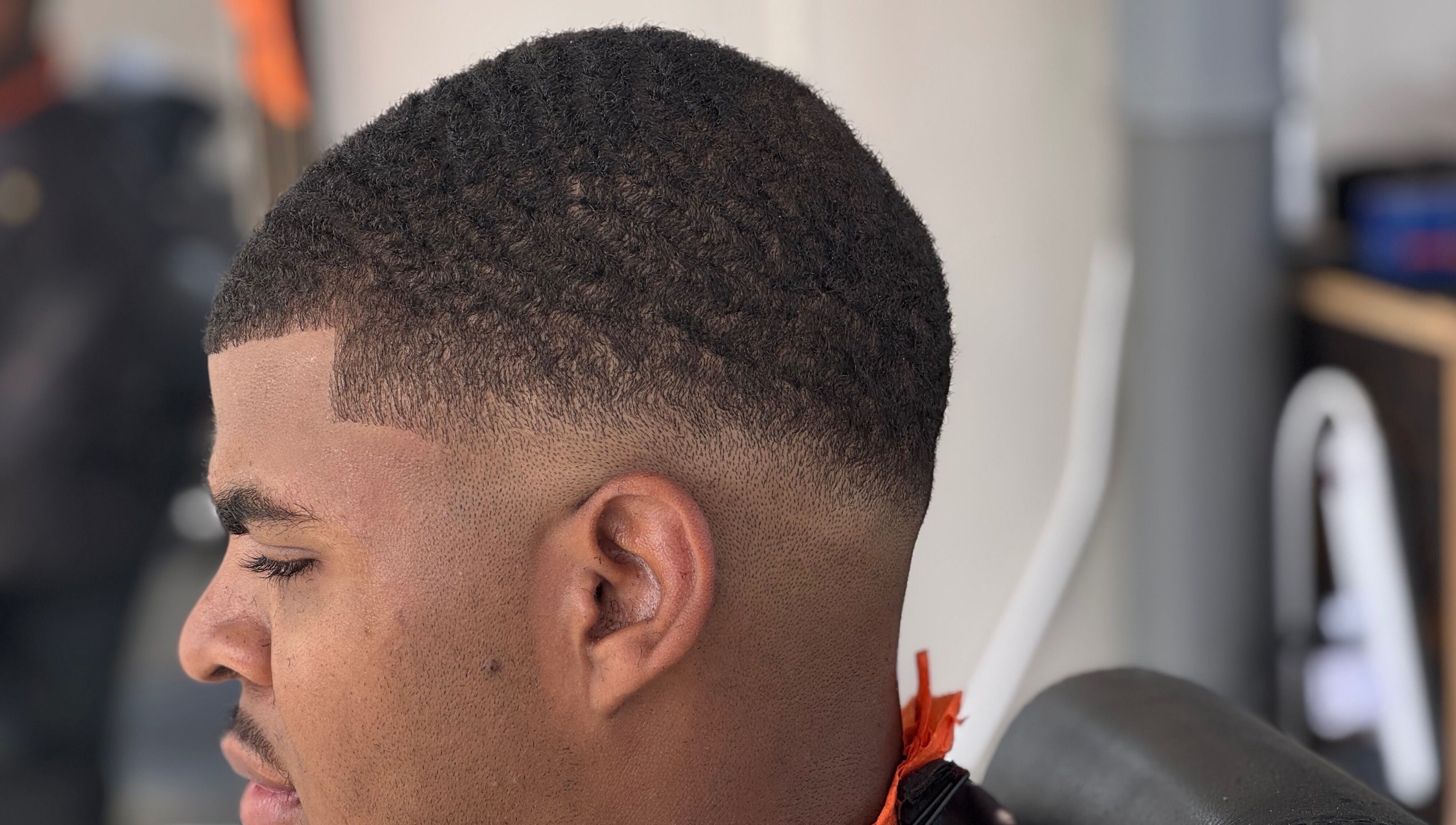 Clean fade haircut at Youngnino, Willemstad, Curaçao, CW. Highlighting expert barber skills.