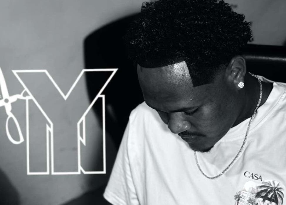 Barber at Youngnino, Willemstad, Curaçao, CW, showcasing precise haircutting skills.