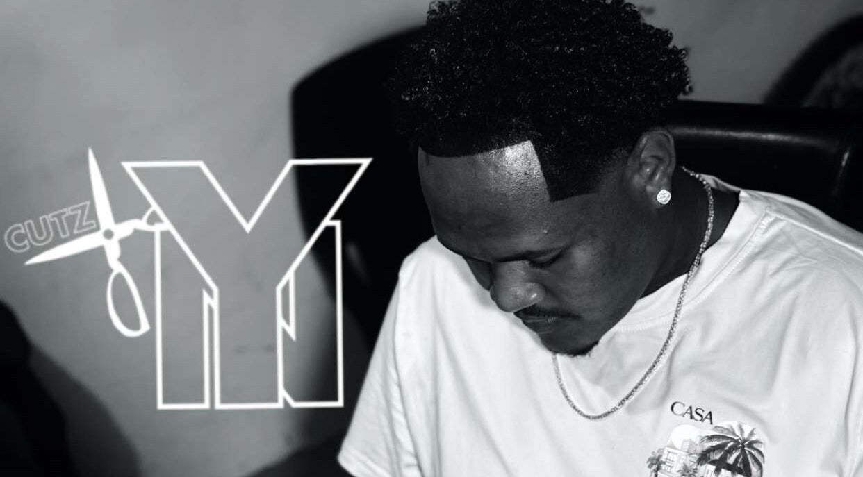 Barber at Youngnino, Willemstad, Curaçao, CW, showcasing precise haircutting skills.